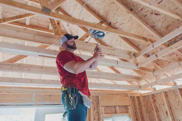 Meeks Electrician repairing interior ceiling electrical wires in newly constructed home