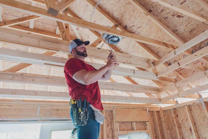 Meeks Electrician repairing interior ceiling electrical wires in newly constructed home
